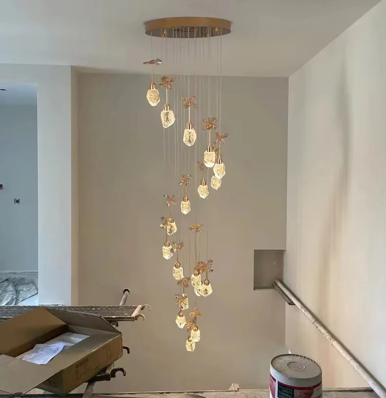 Modern chandelier hanging in a room with construction elements visible