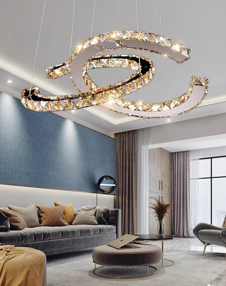 Modern chandelier hanging in a living room with a sofa and decor.
