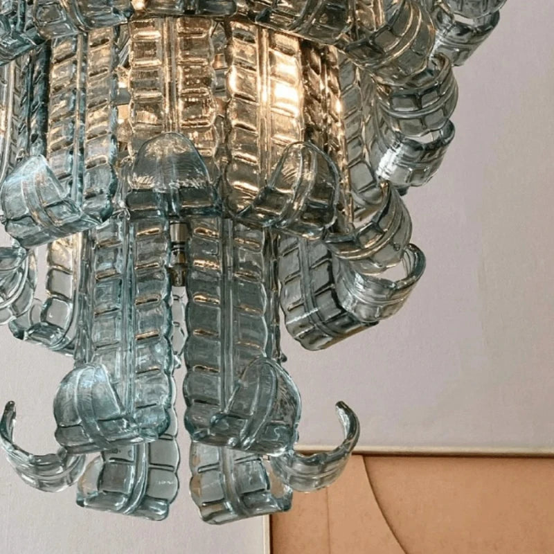 Decorative chandelier with intricate design on a plain background