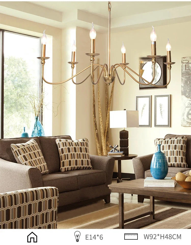 Gold candelabra-style chandelier with curved arms, illuminating a living room space.