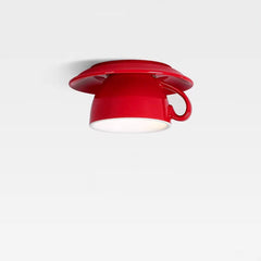 Close-up view of a red ceramic coffee cup ceiling light fixture against a plain white background, showing the handle detail.