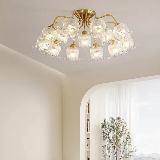 Gold semi-flush ceiling light with multiple glass shades resembling blooming flowers, mounted on a white ceiling.