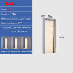 Grey rectangle wall sconce with textured glass in neutral light.