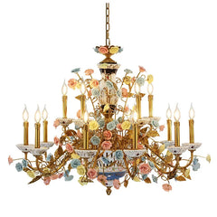 A gold chandelier adorned with numerous colorful ceramic roses and floral accents, featuring candle-style light holders.