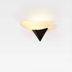 Front view of a wall sconce featuring a frosted white oval shade and a sharp black triangular mounting bracket against a plain white background.