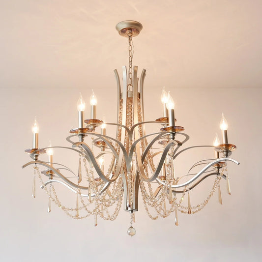 Close-up of the brushed gold metalwork and clear teardrop crystals on the tiered chandelier.