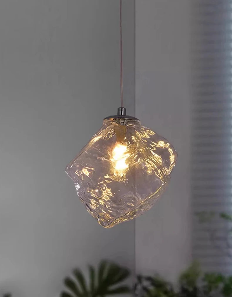 Glass pendant light with a textured design on a neutral background