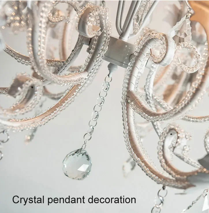 Close-up of a crystal pendant decoration on a light gray background