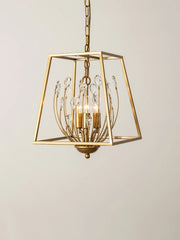 A studio shot of a gold metal cage pendant light with clear teardrop-shaped crystals against a plain white background.