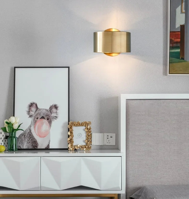 Modern interior with a white cabinet, gold wall lamp, and framed picture of a koala.