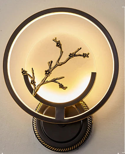 Wall lamp with decorative branch design on a gray background