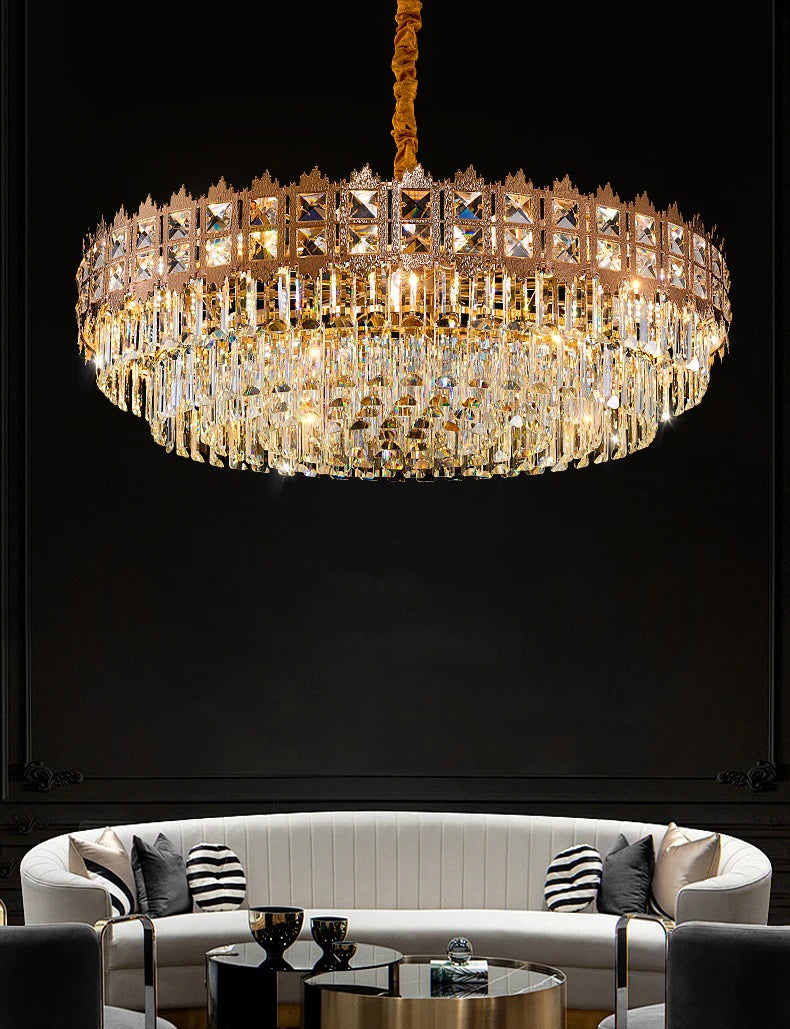 Luxurious chandelier hanging above a modern living room setup with a black background