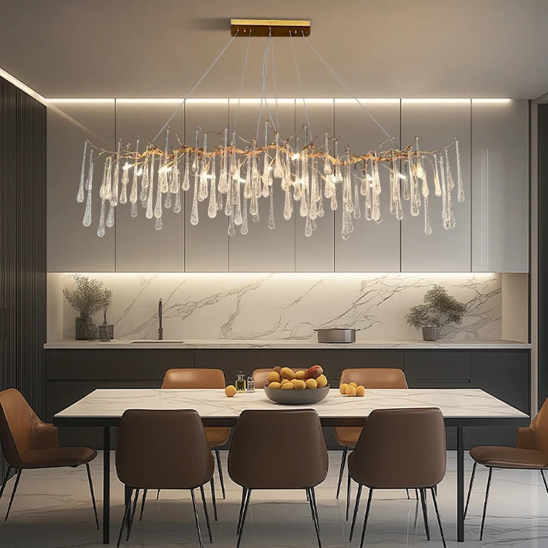 Modern kitchen with a chandelier, dining table, and chairs.