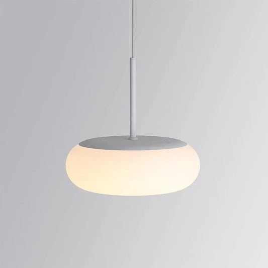 White acrylic pendant light with a thin cord against a gray background