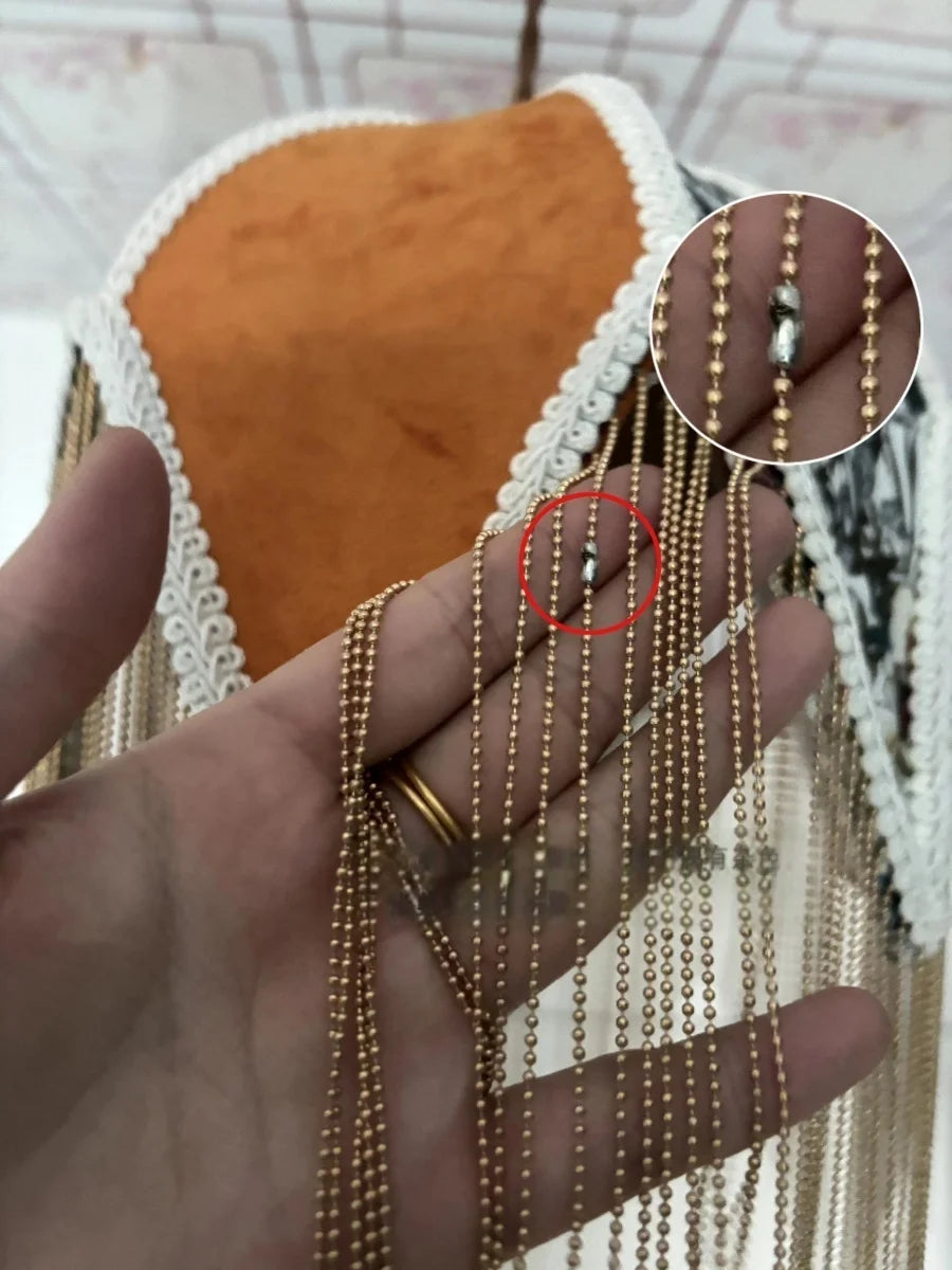 Gold chain on a hand with a close-up inset showing a defect.