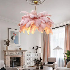 Close-up of a pink feather chandelier with a gold ceiling mount, illuminated from within.