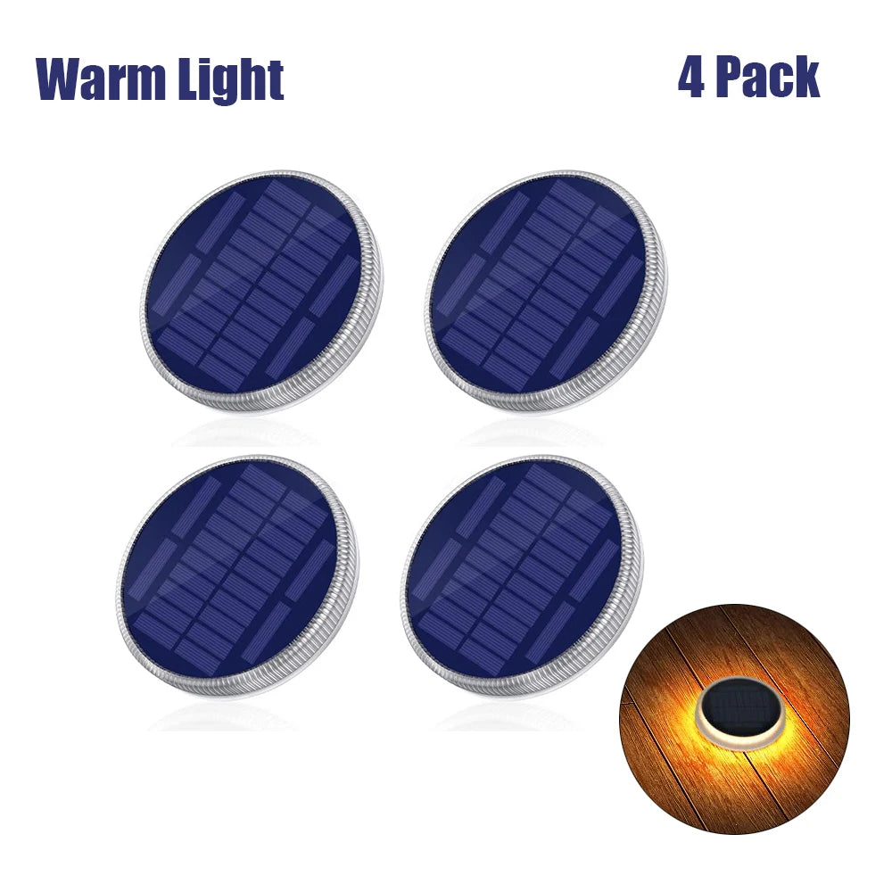 Four solar-powered deck lights with a warm light effect on a white background.