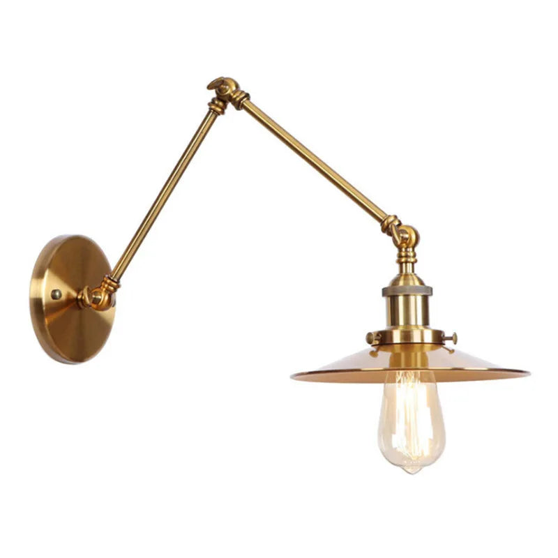 Brushed gold adjustable wall sconce with a fluted shade, seen from the side.