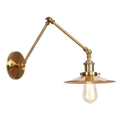Brushed gold adjustable wall sconce with a fluted shade, seen from the side.