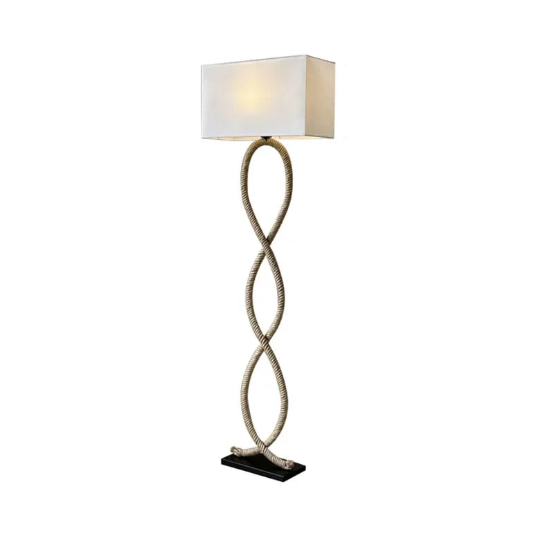 Floor lamp with a twisted design and white shade on a white background
