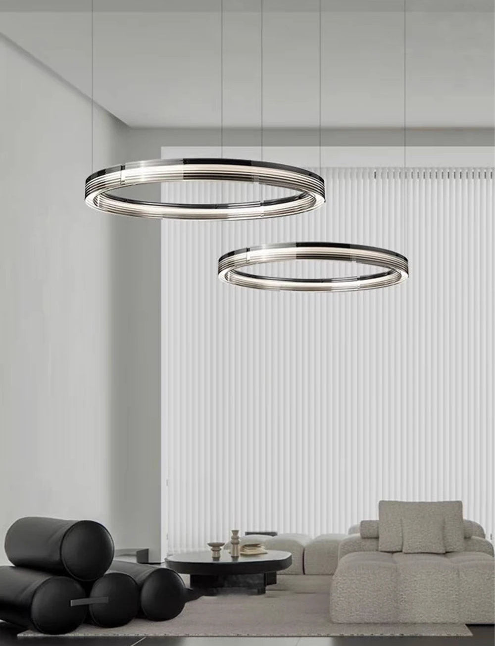 Two modern ceiling lights in a living room setting with a sofa and coffee table.