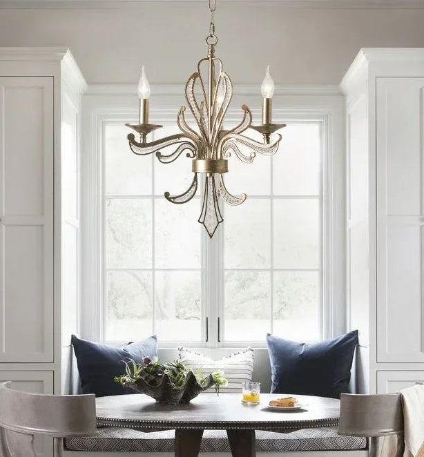 Dining room with a chandelier, table, and chairs.