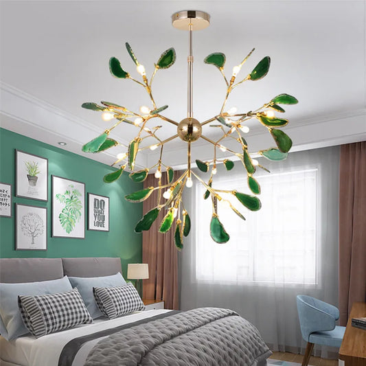 Gold finished sputnik chandelier with green agate slices in a bedroom setting
