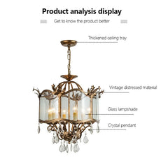 Close-up of a gold chandelier, highlighting the distressed material, glass lampshade, and crystal pendant details.