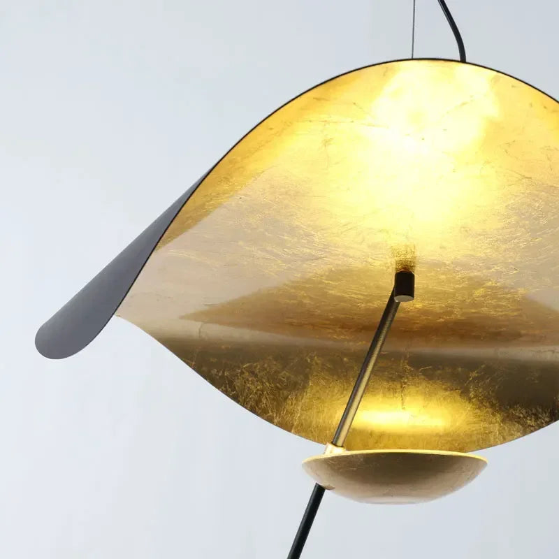 Gold pendant lamp with a gray shade on a light gray background