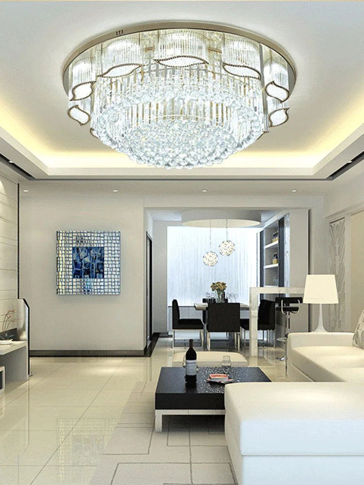 Modern living room with a chandelier, white sofa, and glass coffee table.