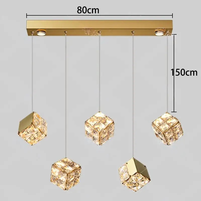 Gold pendant light fixture with crystal-like shades and dimensions on a gray background