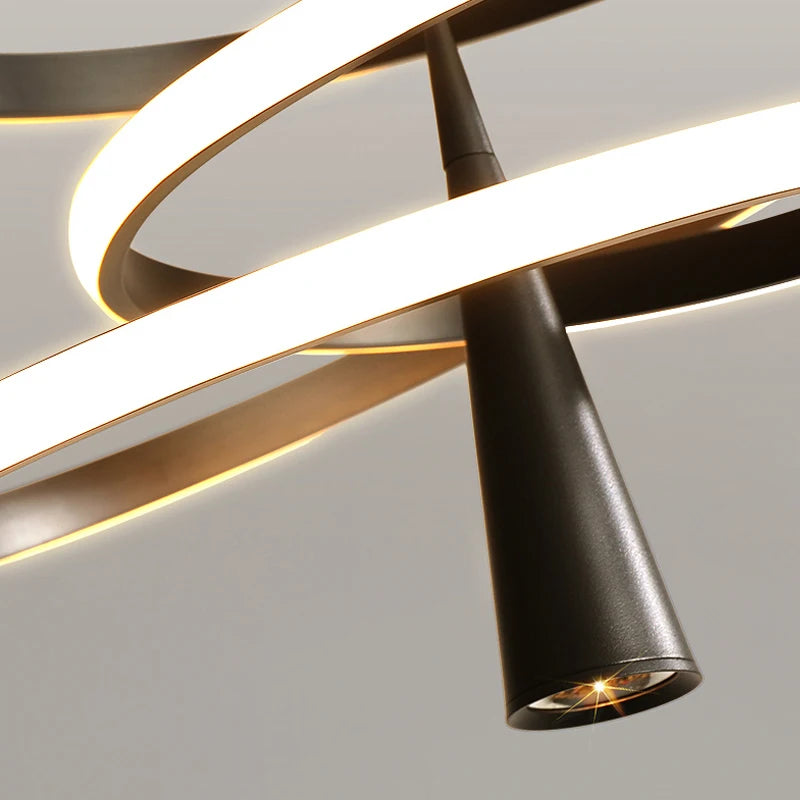 Modern ceiling light fixture with black and gold design on a neutral background