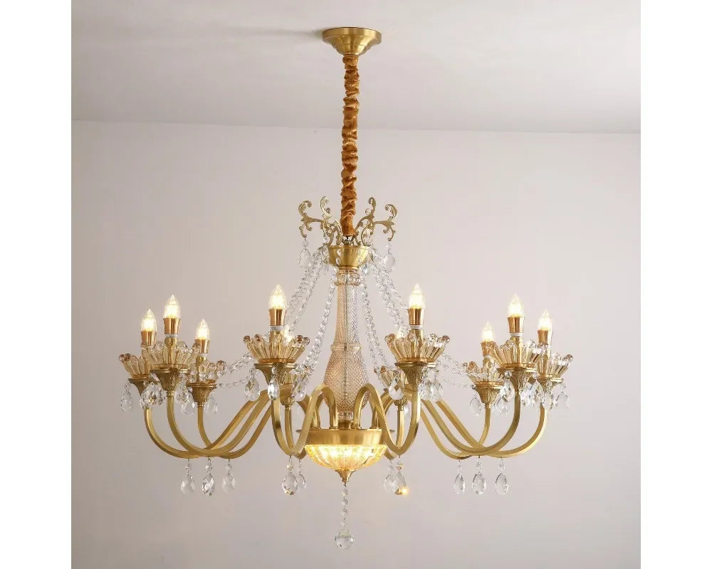 A gold candelabra chandelier with multiple arms adorned with faceted crystals, hanging from a ceiling.