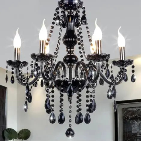 Black crystal chandelier with five candles on a white wall background