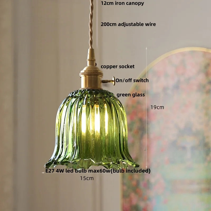 Green glass pendant light with measurements and features on a neutral background