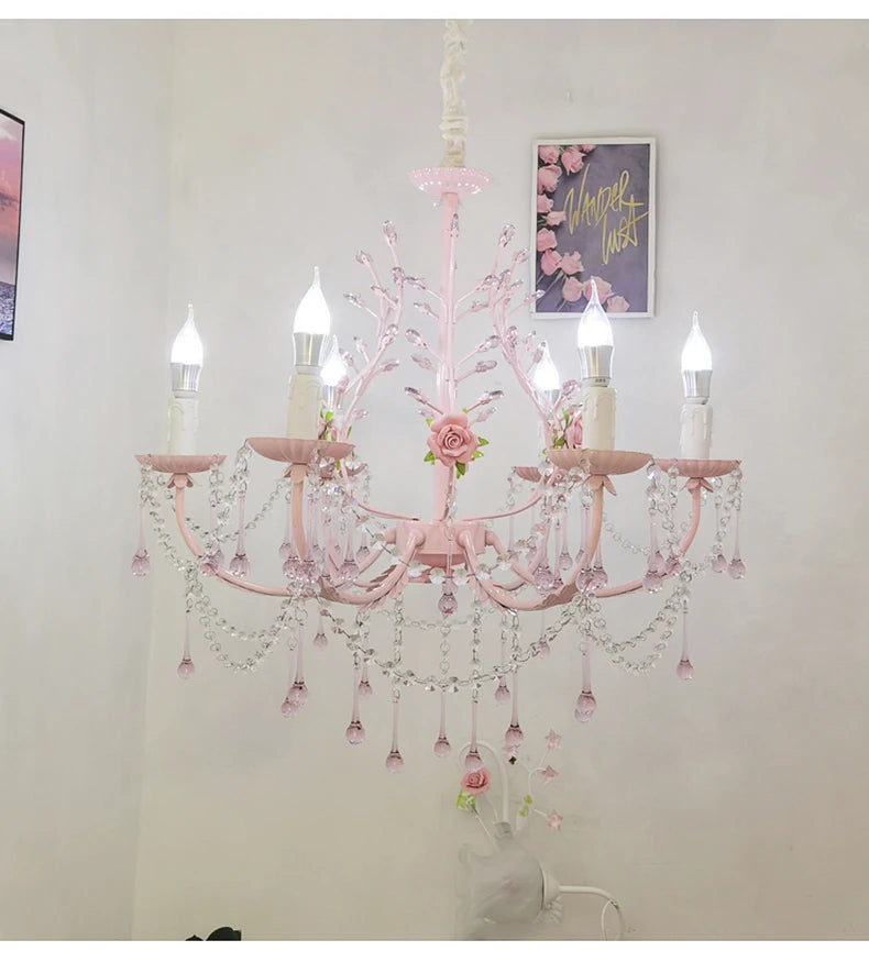A wider shot of the pink floral crystal chandelier installed in a room, showcasing its scale and design.