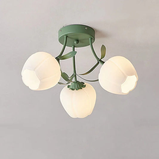 Close-up of a green semi-flush mount ceiling light featuring three white frosted glass tulip-shaped shades with green metal accents.