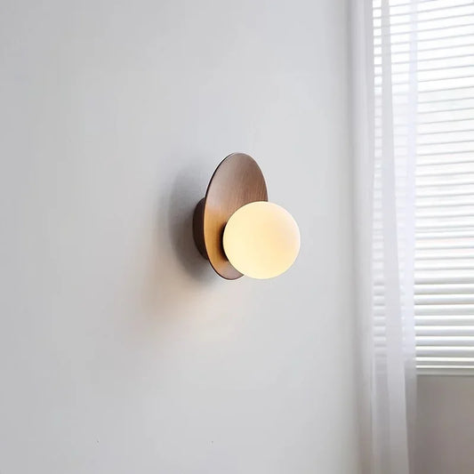Side view of a wood arc wall sconce featuring a frosted glass globe.