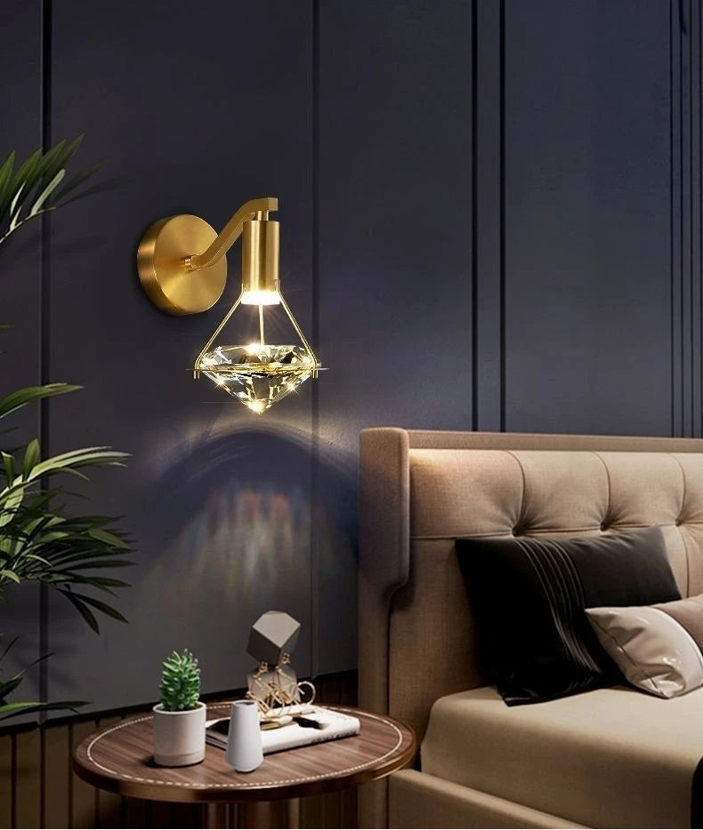 Modern wall light fixture in a living room setting with a sofa and decorative items.