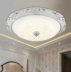 Decorative ceiling light fixture in a room with floral wallpaper