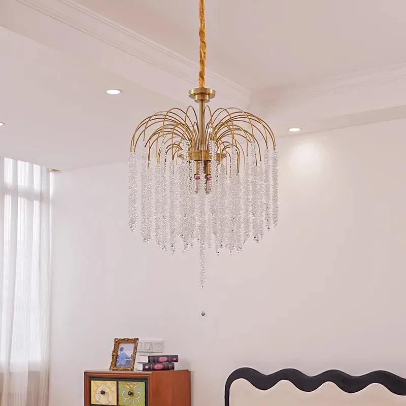 A gold chandelier with crystal bead strands is shown from a slightly lower angle.
