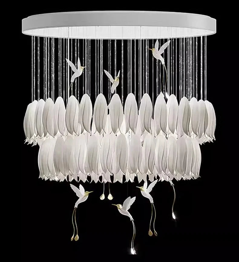 Chandelier with white feather-like design and bird figurines on a black background