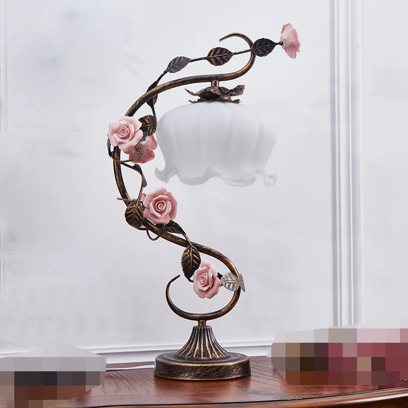 Decorative table lamp with floral design on a white background