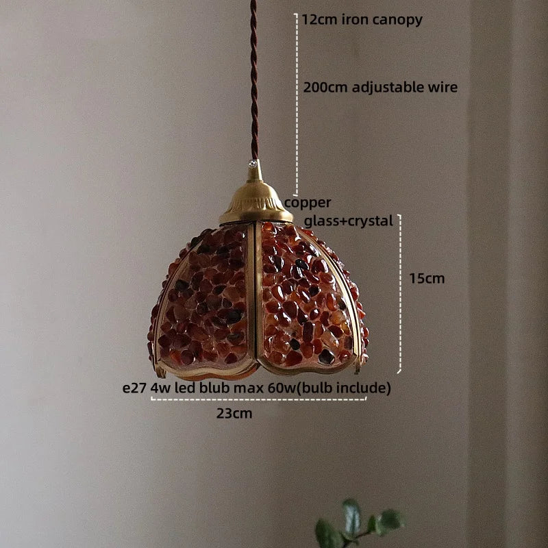 Decorative pendant light with measurements on a plain background