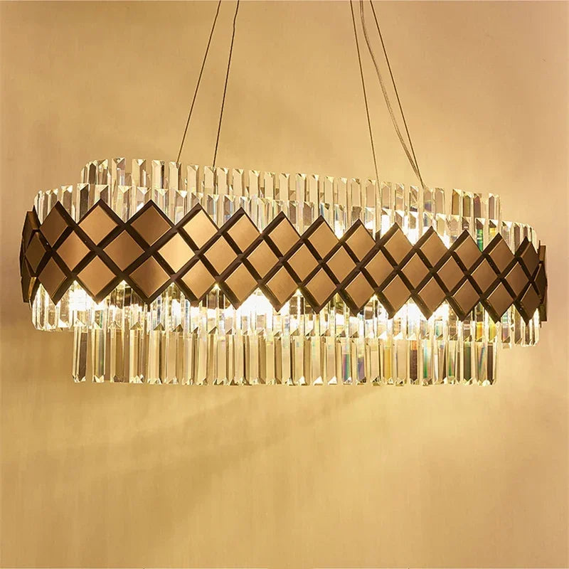 Close-up of a gold and crystal tiered chandelier showcasing the geometric diamond pattern and faceted crystals.