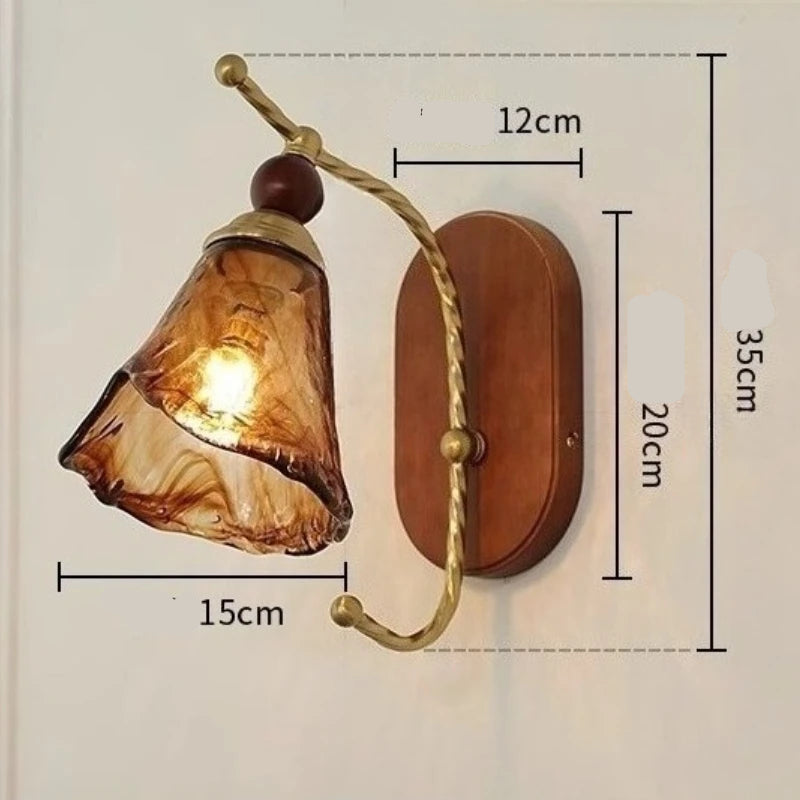Wall-mounted lamp with brown glass shade and wooden base, shown with measurements on a light gray background.