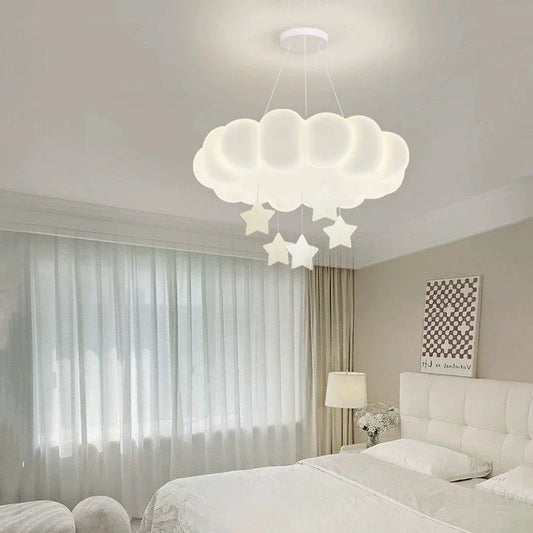 Close-up of a white cloud-shaped pendant light with star accents hanging from the ceiling.