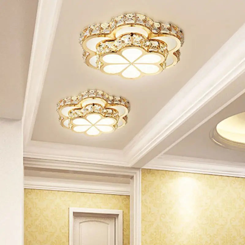 Two gold and crystal flower flush mount ceiling lights installed on a white ceiling.