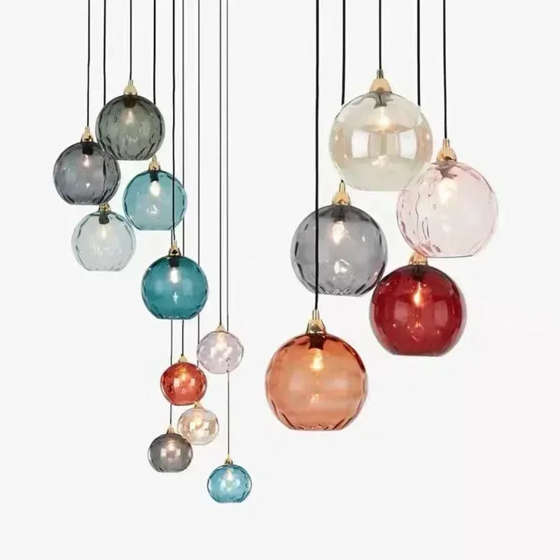 Assortment of colorful textured glass globe pendant lights displayed together