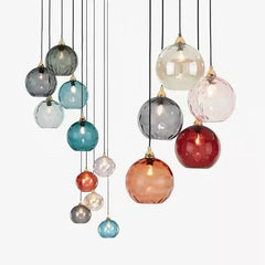 Assortment of colorful textured glass globe pendant lights displayed together